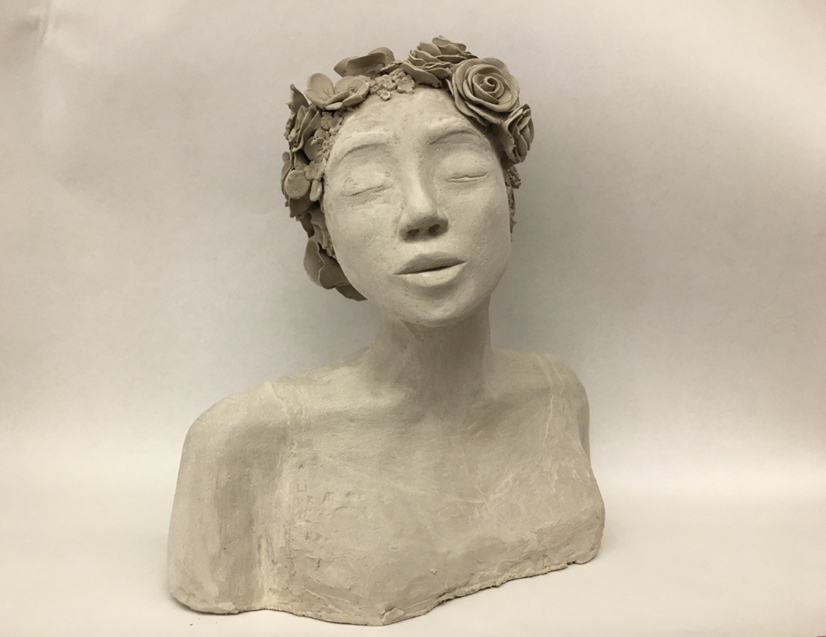 Clay bust with a sculpted flower crown by Faye, front view